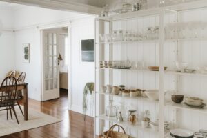 White metal open industrial shelves styled with serving ware.