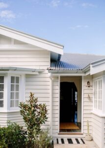 A shot of a creamy painted Queenslander, looking straight into the front door.