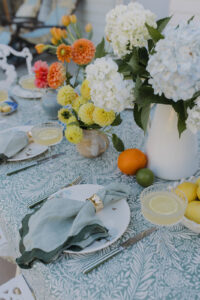 A styled outdoor table with fresh, colourful flowers.