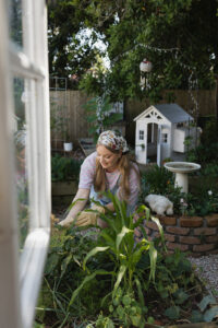 A woman with styled gardening clothes, gardening.