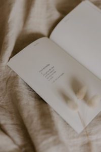 An open book sits on a sheet.