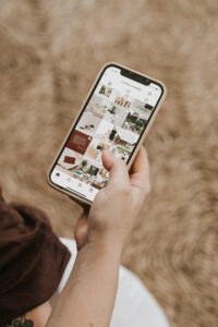 A phone open on Instagram being held by a hand.