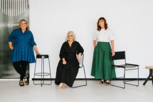 This is a photo from the ebb&flow Design branding shoot that showcases their team and some of their furniture and materials.