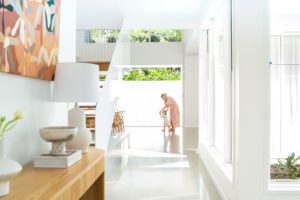 The entrance of a modern home where a mother and daughter play.