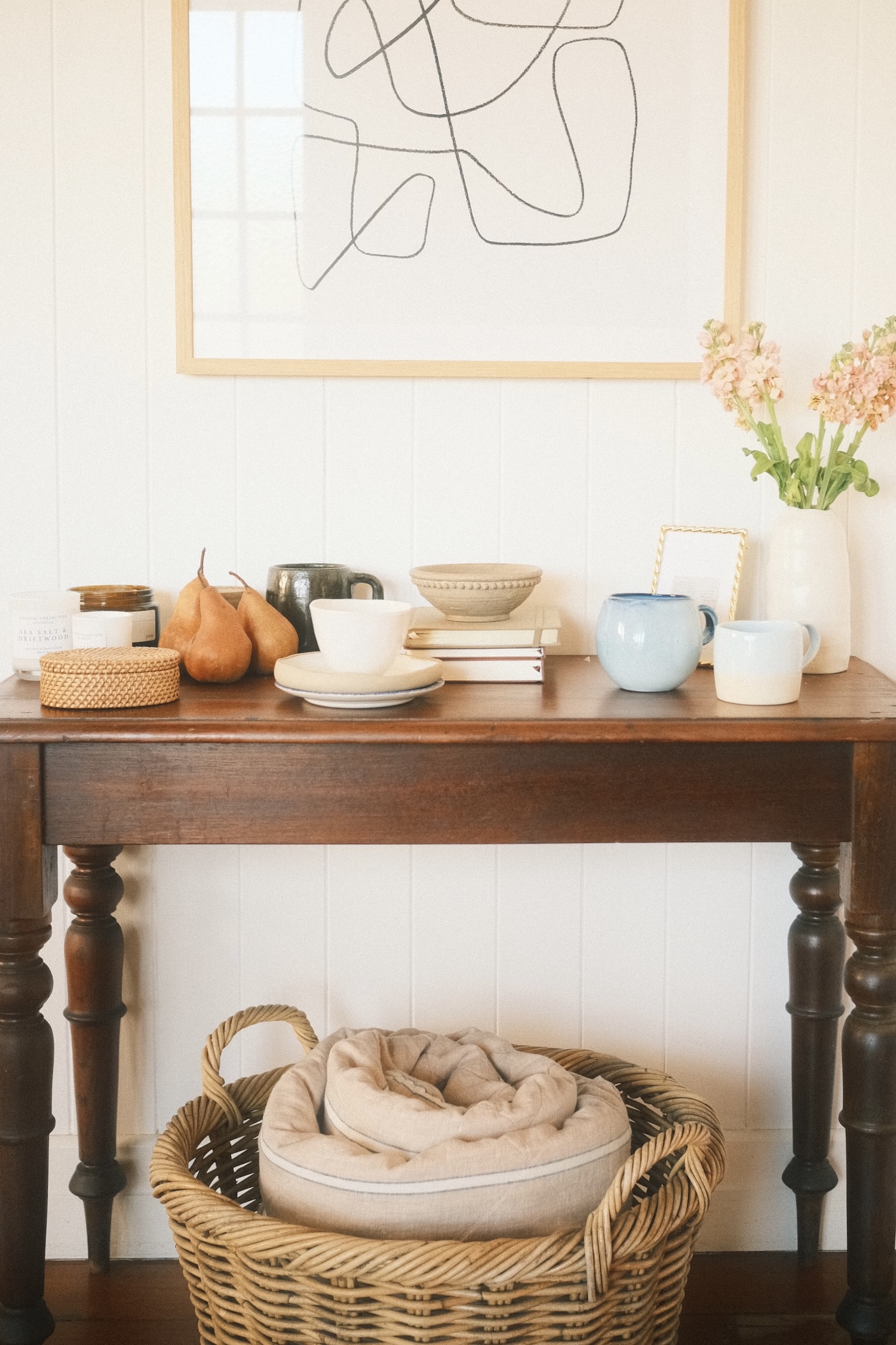 A vintage table holding dishes, vases and other props.