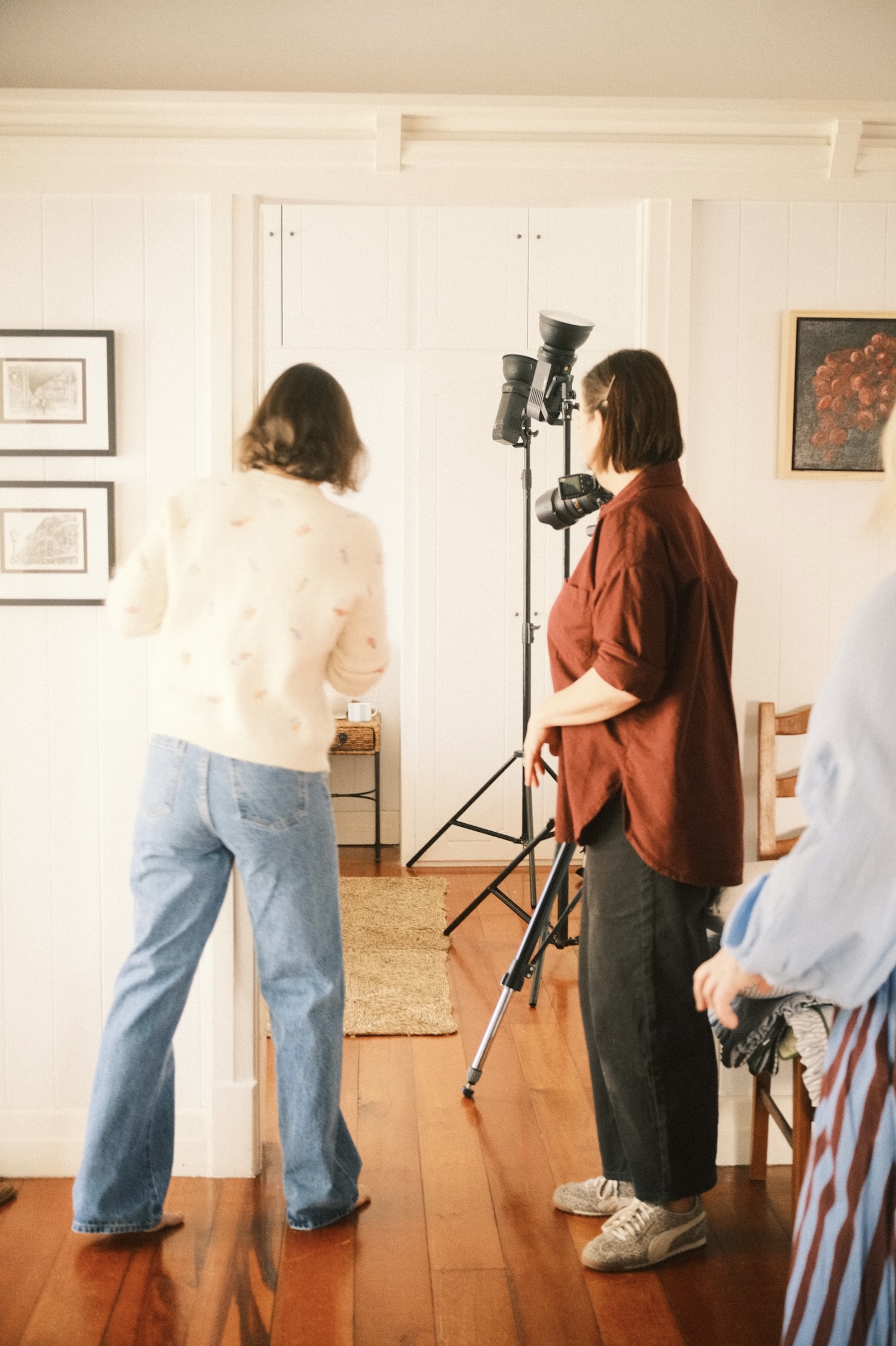 Three women styling and photographing a country style Queenslander home.