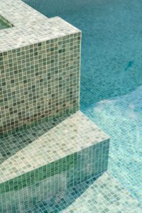 A detail shot of mosaic tiles in a pool.