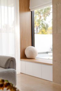A custom window seat with a round boucle cushion.
