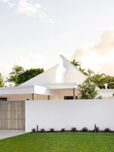 Pitched roofline of a white house facade.