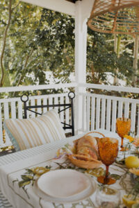 Looking past a festive spread that covers an outdoor table on a renovated Queenslander veranda.
