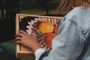 Artist unloads artwork from the back of a Defender Land Rover.