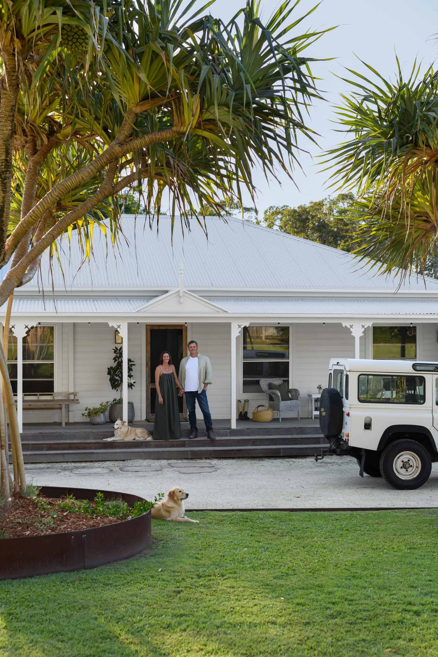 The owners of Lake Weyba Country House standing out the front on the verandah.
