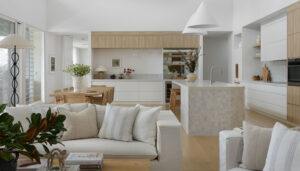 An interior styling photo of a lounge room from the lounge, through to the dining and kitchen.