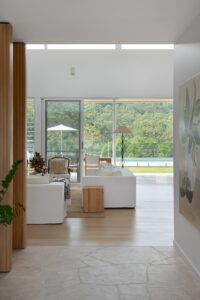 A modern living area viewed from the entryway, styled with Coco Republic lounges.