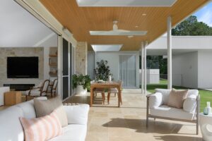 A modern outdoor living area styled with neutral furniture.