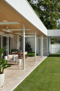 A modern outdoor living area styled with neutral furniture.
