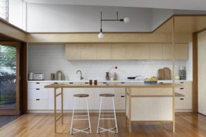 A modern kitchen with ply wood cabinetry.