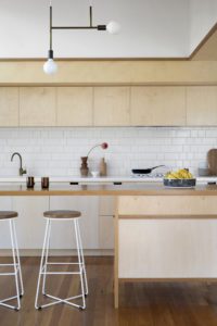 A modern kitchen with ply wood cabinetry.