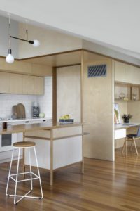 A modern kitchen with ply wood cabinetry.