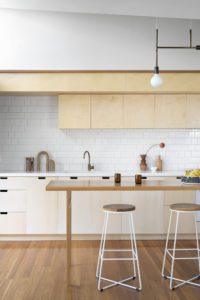 A modern kitchen with ply wood cabinetry.
