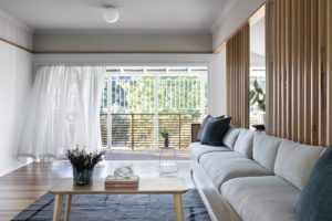A modern custom lounge with grey, navy and burgundy cushions.