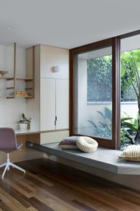 A modern window seat and home office nook in a Queenslander extension.