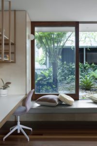 A modern window seat and home office nook in a Queenslander extension.