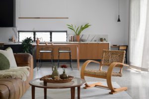 A modern granny flat with concrete floors and vintage styling details.