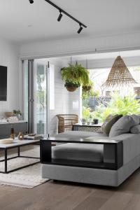 A grey lounge and rug sit in the living room.