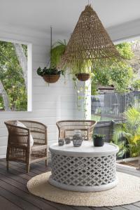 A pendant light hangs down over a coffee table on the deck.