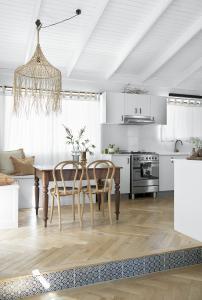 A pendant light hangs over a vintage table.