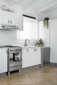 A white VJ kitchen with black handles.