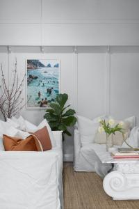 A white lounge lounge with a marble coffee table decorate a lounge room.