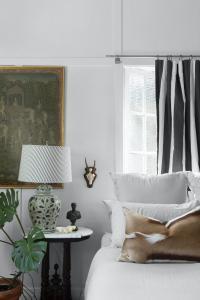 A black and white striped curtain hangs in a bedroom decorated with vintage styling.