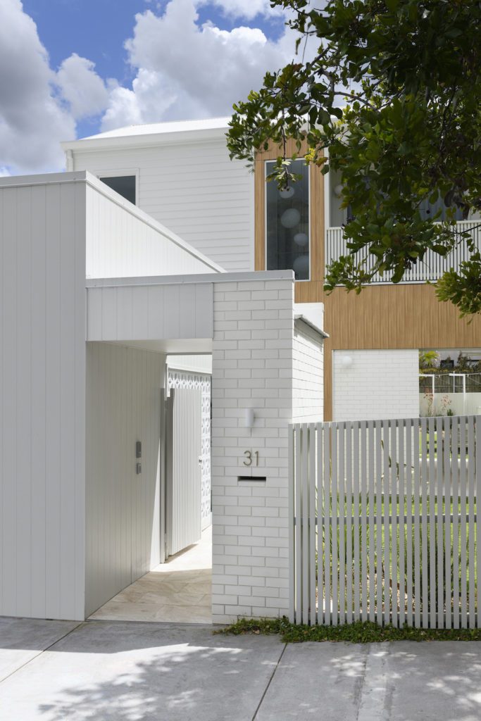 White brick and clad home exterior shot for Inside Out Magazine.