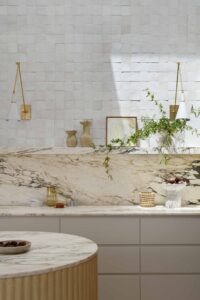 Marble kitchen styled with handmade ceramics and decor.