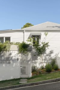 The exterior of a white modern Queenslander.
