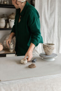 Ceramic artist Kerri of Nioka Clay works to build a vase in her home studio.