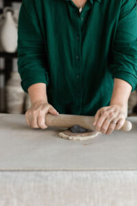 Ceramic artist Kerri of Nioka Clay works to build a vase in her home studio.