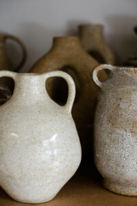 A close up of the speckled ceramic vases in the home studio of Nioka Clay.
