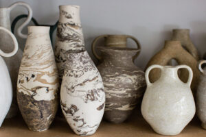 A close up of the marbled and speckled ceramic vases in the home studio of Nioka Clay.