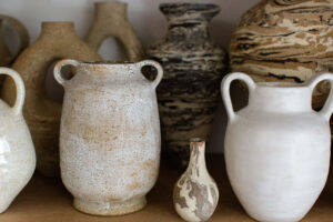 A close up of the marbled and speckled ceramic vases in the home studio of Nioka Clay.