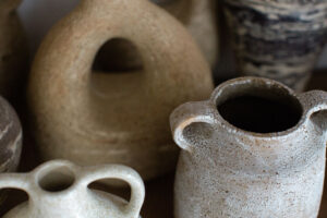 A close up of the speckled ceramic vases in the home studio of Nioka Clay.