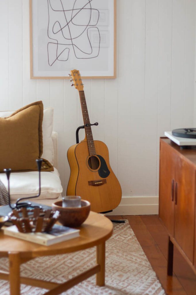 Picture of a Maton guitar in a living room.