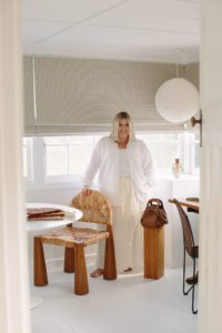 Stylist Hayley Jenkin stands in her studio room.