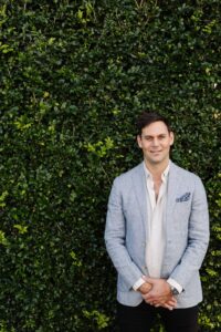 Steve from Sage Property Advisers stands in front of a hedge on a property.