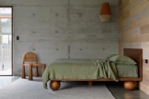 Modern bedroom with a Sarah Ellison Studio bed, and Rachel Donath chair.