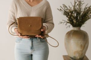 A model holds a handmade bag.