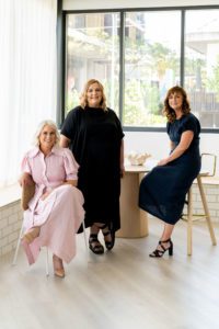 This is a photo from the ebb&flow Design branding shoot that showcases their team and some of their furniture and materials.