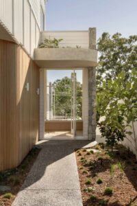 An outdoor pathway alongside a modern architectural home.